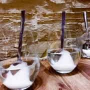  close-up photo of a spoon scooping white vanilla fondant from a jar.