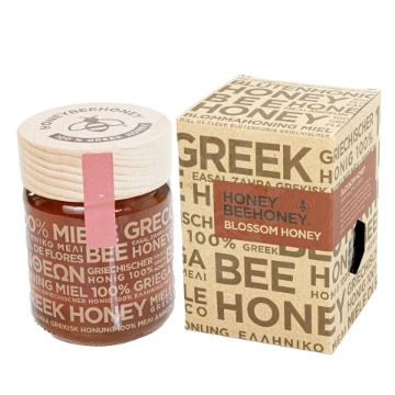 Pure Greek Raw Blossom Honey with Wildflowers – Natural and Floral Essence  Premium Greek Raw Blossom Honey presented with wildflowers, emphasizing its natural and floral origins.
