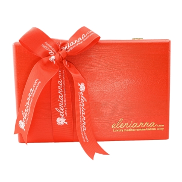 Red pine wooden gift box with a swing lid filled with Greek gourmet food products. Red pine wooden gift box with a swing lid filled with Greek gourmet food products.