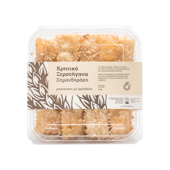 Close-up top view of Simantiraki Xerotigana box showing golden fried dough topped with crushed almonds.