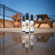 A selection of Biolea organic stone-milled olive oils reflecting on a terrace, showcasing the PDO Chanion Kritis certification.