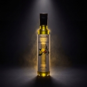 Professional studio shot of Biolea Lemoni Organic Condiment with dramatic spotlighting and golden mist, showcasing the premium glass bottle and Greek origin.