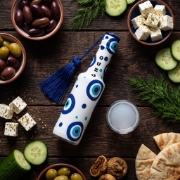 Greek Ouzo 50ml White Mini Bottle with Aegean Blue Evil Eye Charm on a clean ecommerce background